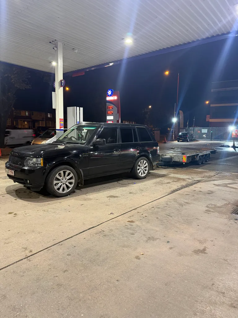 Land Rover towing a flatbed recovery truck