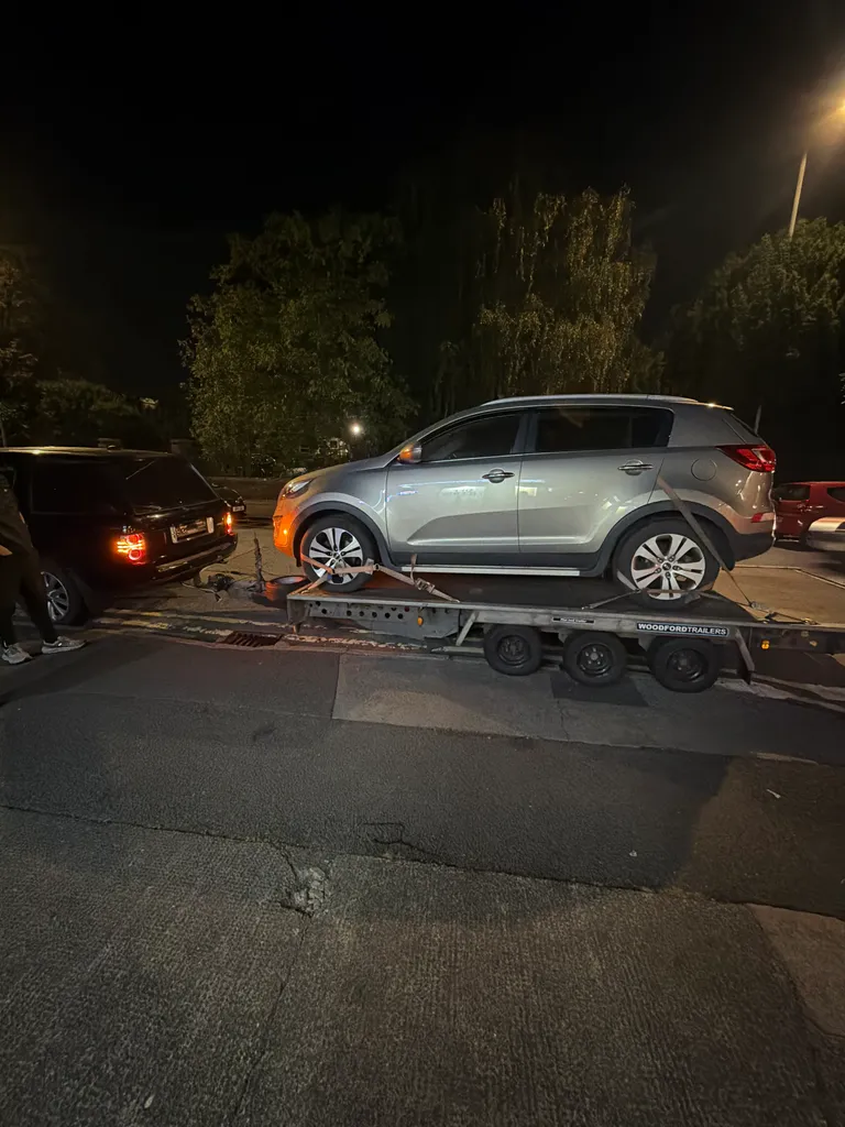 Mazda being recovered on a flatbed recovery truck