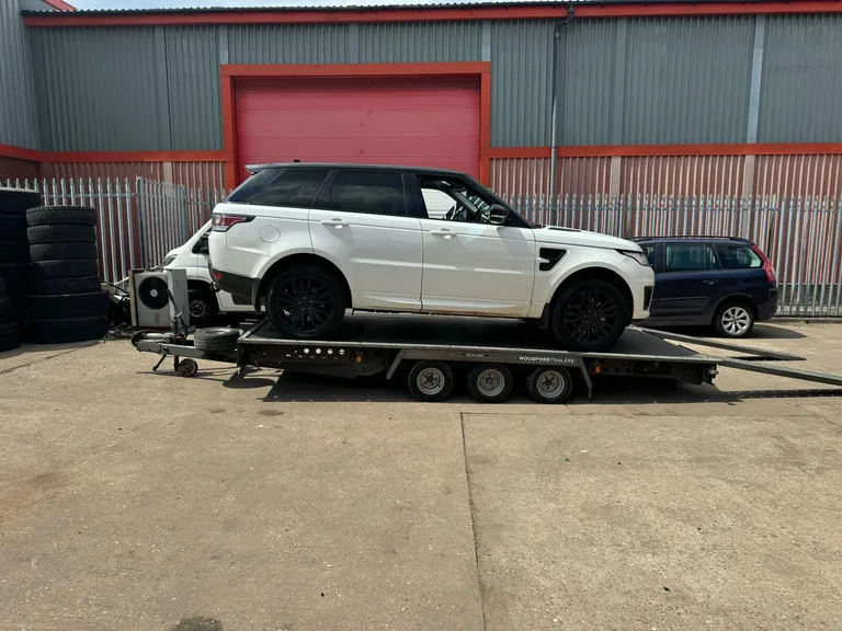Range Rover on a recovery truck bed side view